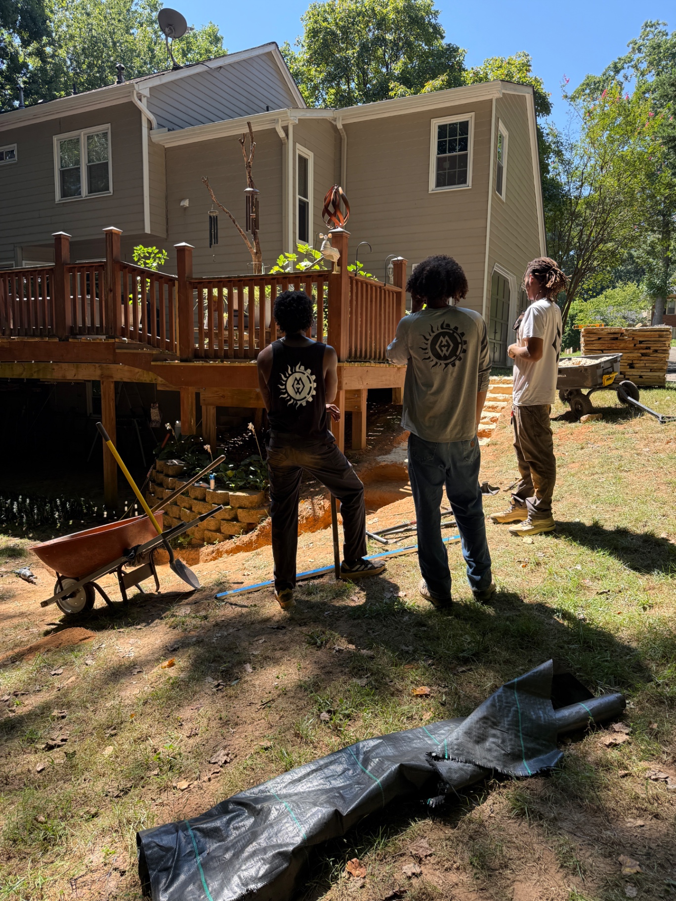 Solar Garde crew planning a backyard drainage and patio project